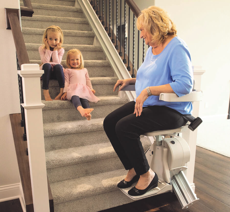 people using stairlift on stairs